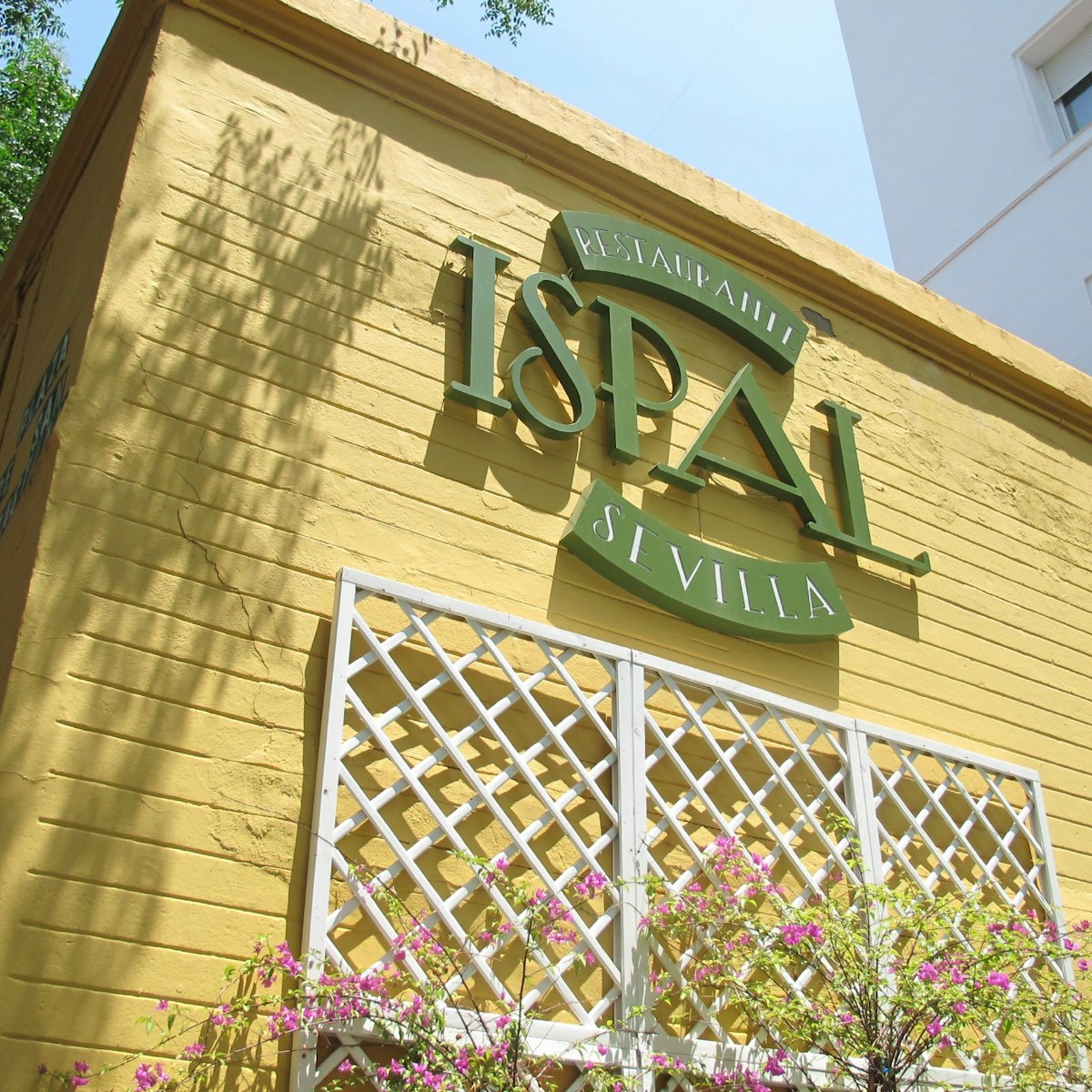 Ispal restaurant yellow wall with sign.