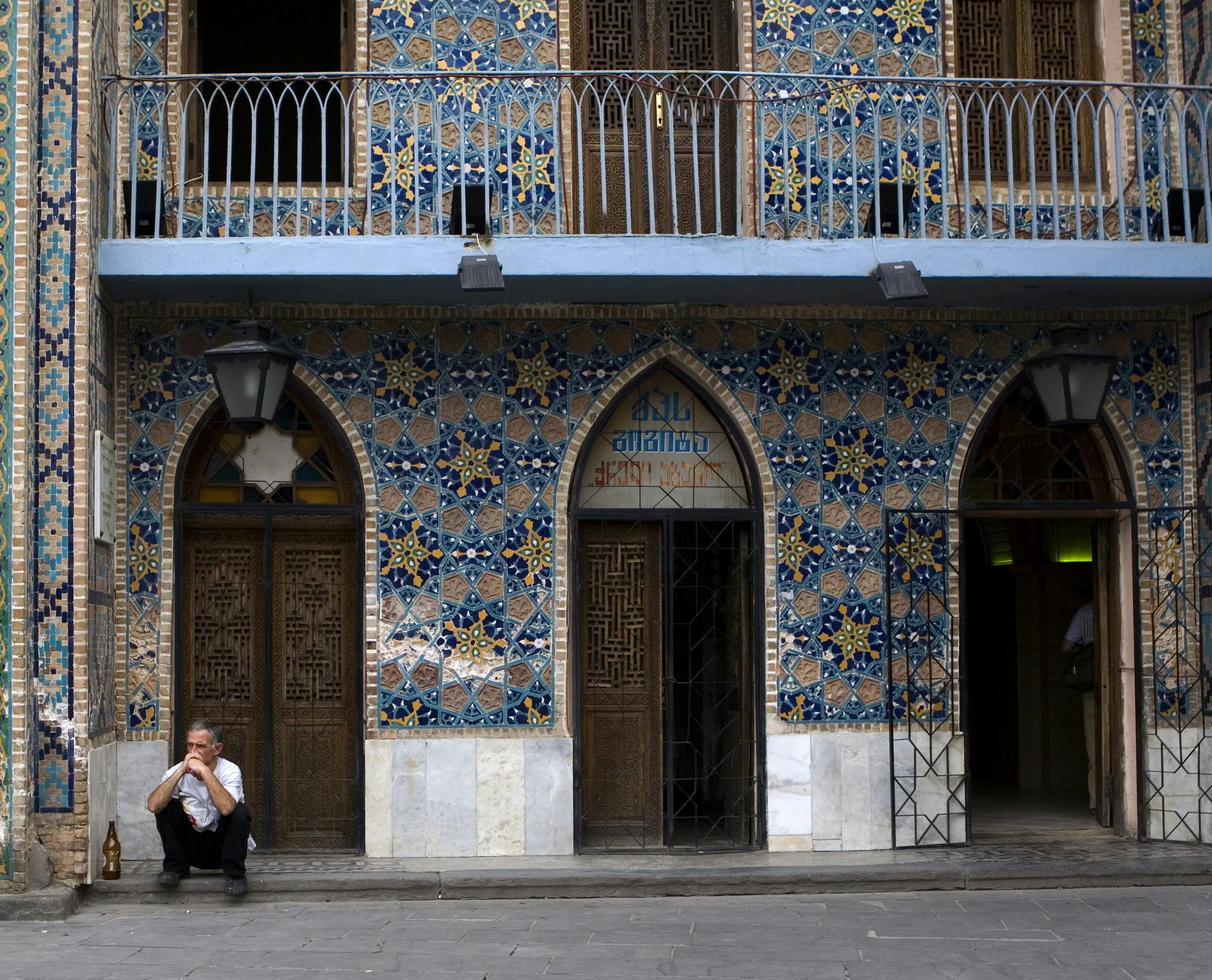 Blue-tiled mosaic facade of Orbeliani Baths in the Abanotubani area of the Old Town.
