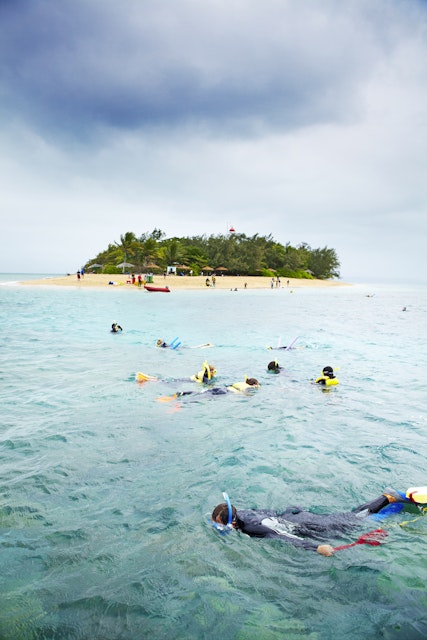 Tourists snorkeling offshore from Low Isles.