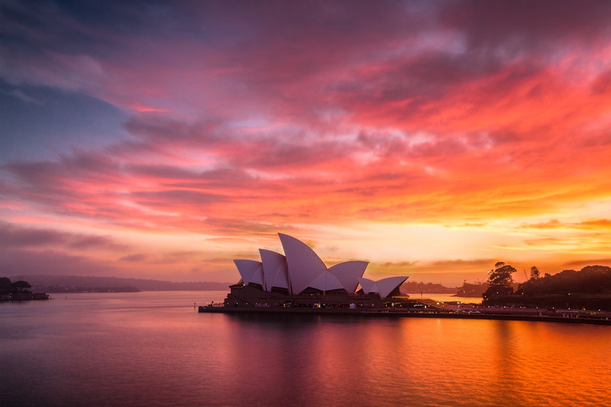 A burning dawn sky above the beautiful Sydney Opera House.