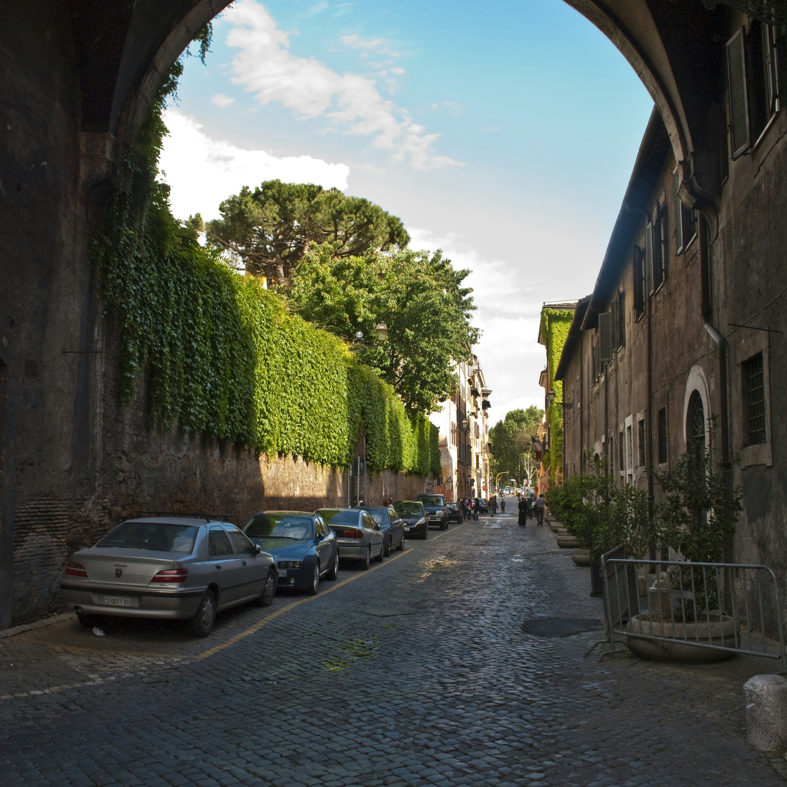 Via Giulia in Centro Storico underneath the Arco Farnese, looking along the ivy clad walls of the Palazzo Farnese on the left.