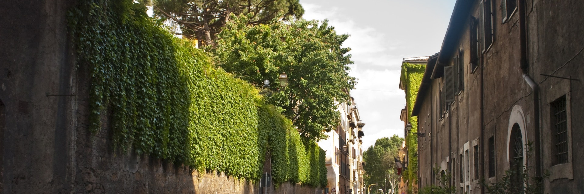 Via Giulia in Centro Storico underneath the Arco Farnese, looking along the ivy clad walls of the Palazzo Farnese on the left.