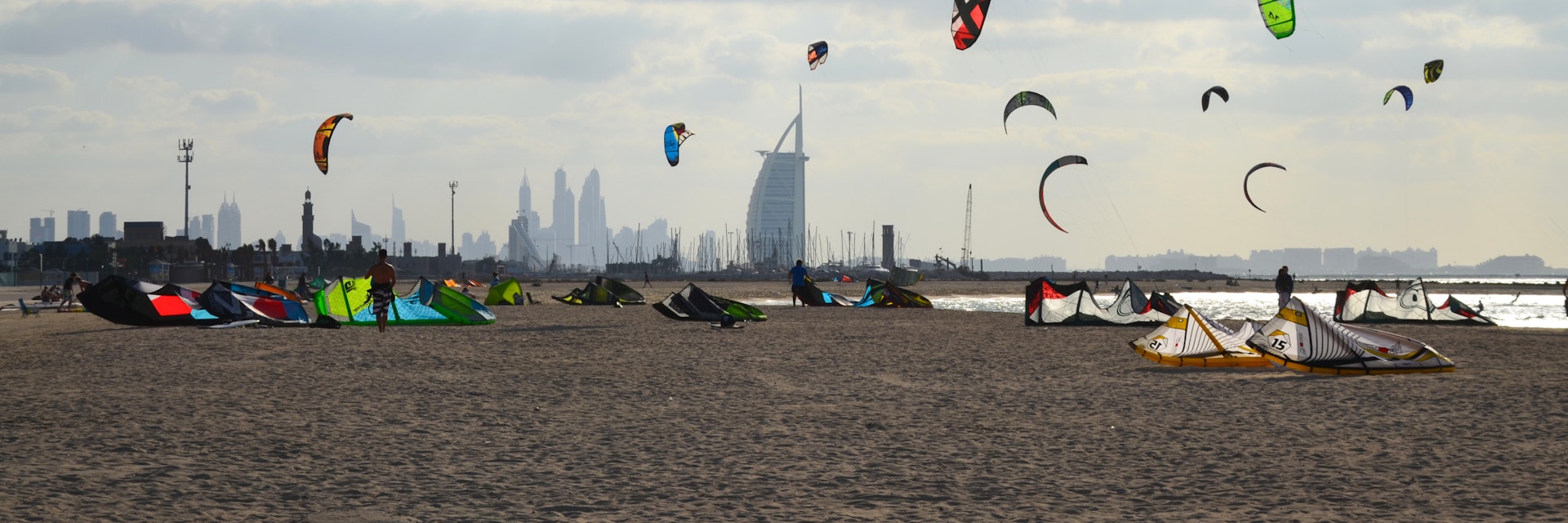 11/30/2014. Kite beach in Jumeirah, Dubai, United Arab Emirates. A stretch of the beach designated for the kite surfers. The iconic Burj Al Arab is seen on the background.; Shutterstock ID 664989337; Your name (First / Last): Lauren Keith; GL account no.: 65050; Netsuite department name: Online Editorial; Full Product or Project name including edition: Authentic Dubai Article