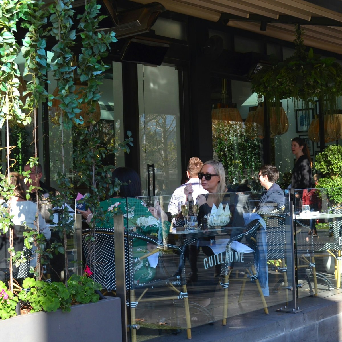 People lunching on the terrace at Bistro Guillaume, Crown.