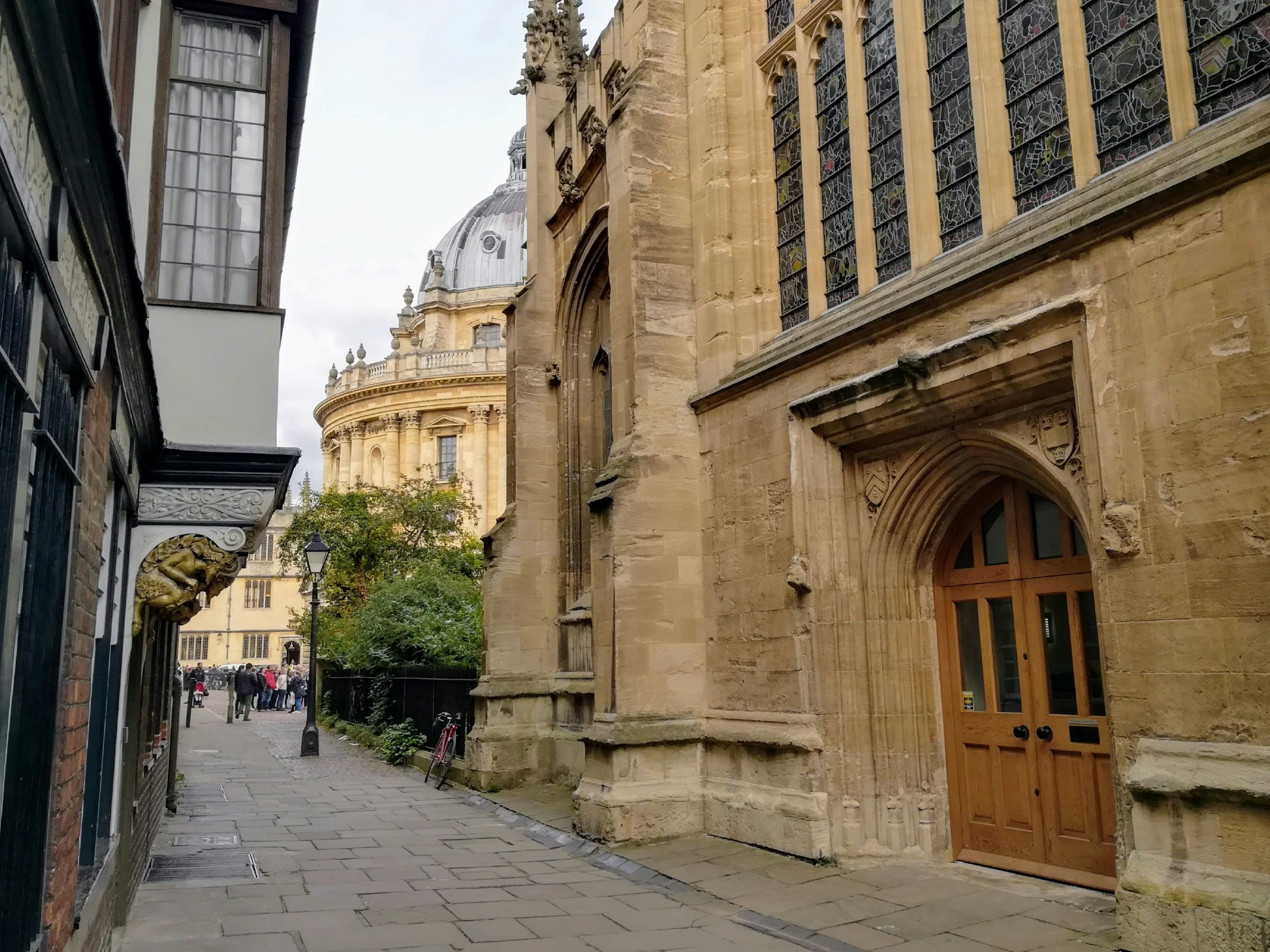 A side view of door in St Mary's Passage with the Radcliffe Camera in background.