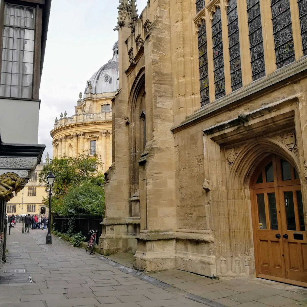 A side view of door in St Mary's Passage with the Radcliffe Camera in background.