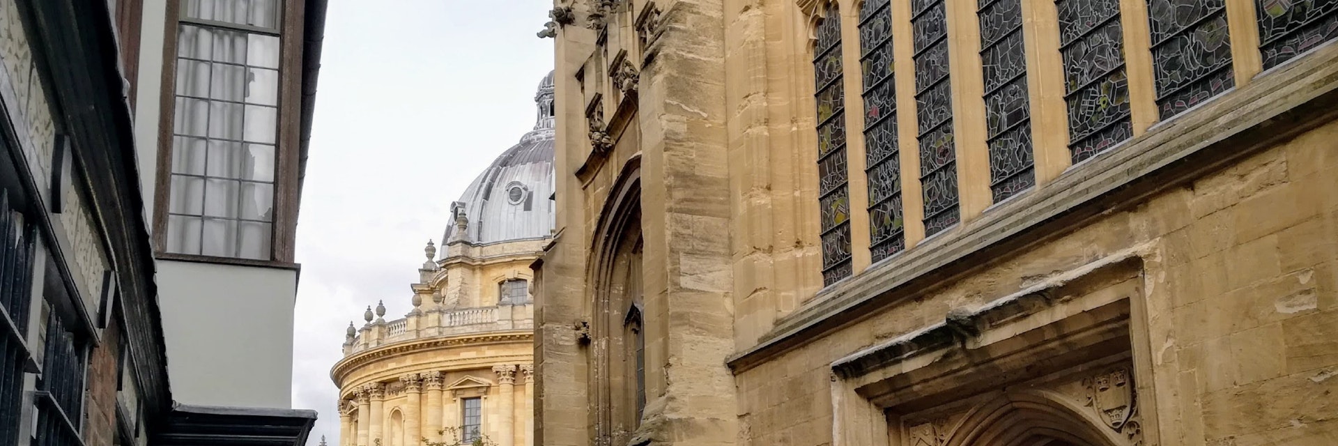 A side view of door in St Mary's Passage with the Radcliffe Camera in background.