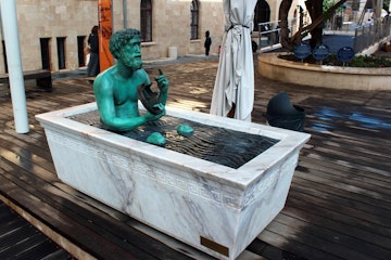 HAIFA, ISRAEL - DECEMBER 5,2013: Statue of Archimedes in a bathtub, demonstrating principle of buoyant force. Located at Madatech, Israel's National Museum of Science, Technology, and Space.; Shutterstock ID 611544791; Your name (First / Last): Lauren Keith; GL account no.: 65050; Netsuite department name: Online Editorial; Full Product or Project name including edition: Haifa Guides app update