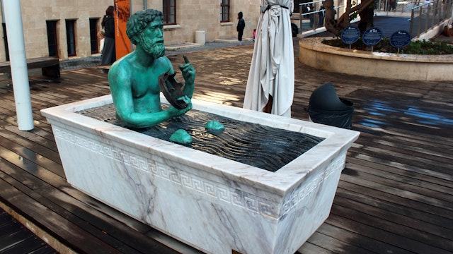 HAIFA, ISRAEL - DECEMBER 5,2013: Statue of Archimedes in a bathtub, demonstrating principle of buoyant force. Located at Madatech, Israel's National Museum of Science, Technology, and Space.; Shutterstock ID 611544791; Your name (First / Last): Lauren Keith; GL account no.: 65050; Netsuite department name: Online Editorial; Full Product or Project name including edition: Haifa Guides app update