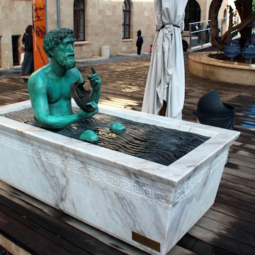 HAIFA, ISRAEL - DECEMBER 5,2013: Statue of Archimedes in a bathtub, demonstrating principle of buoyant force. Located at Madatech, Israel's National Museum of Science, Technology, and Space.; Shutterstock ID 611544791; Your name (First / Last): Lauren Keith; GL account no.: 65050; Netsuite department name: Online Editorial; Full Product or Project name including edition: Haifa Guides app update