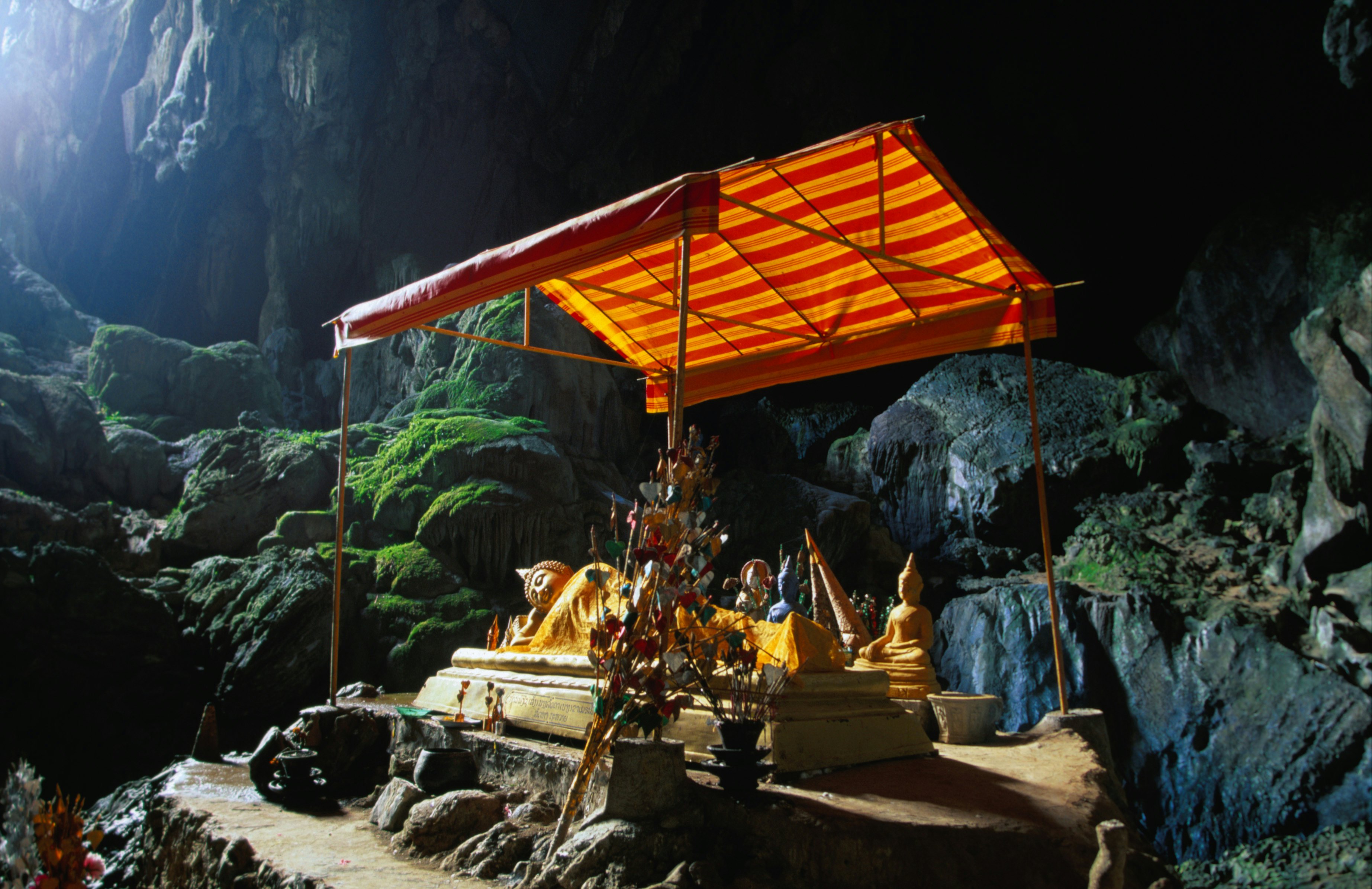 Tham Phu Kham cave, with the Thai bronze reclining Buddha in the distance, Vang Vieng