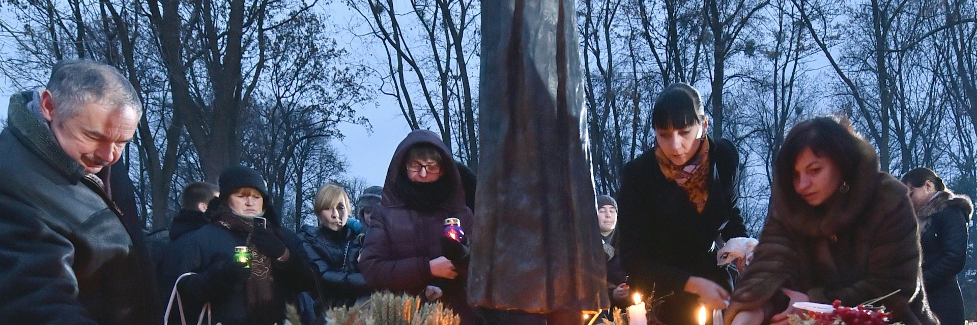 Ukrainians place candles in memory of the victims of the Holodomor famine during a ceremony at the Holodomor memorial in Kiev on November 22, 2014. Ukraine marked 81 years since the Stalin-era Holodomor famine, one of the darkest pages in its entire history that left millions dead and which is regarded by many as a genocide. The 1932-33 famine took place as harvests dwindled and Soviet leader Josef Stalin's police enforced the brutal policy of collectivising agriculture by requisitioning grain and other foodstuffs. AFP PHOTO/ SERGEI SUPINSKY        (Photo credit should read SERGEI SUPINSKY/AFP/Getty Images)