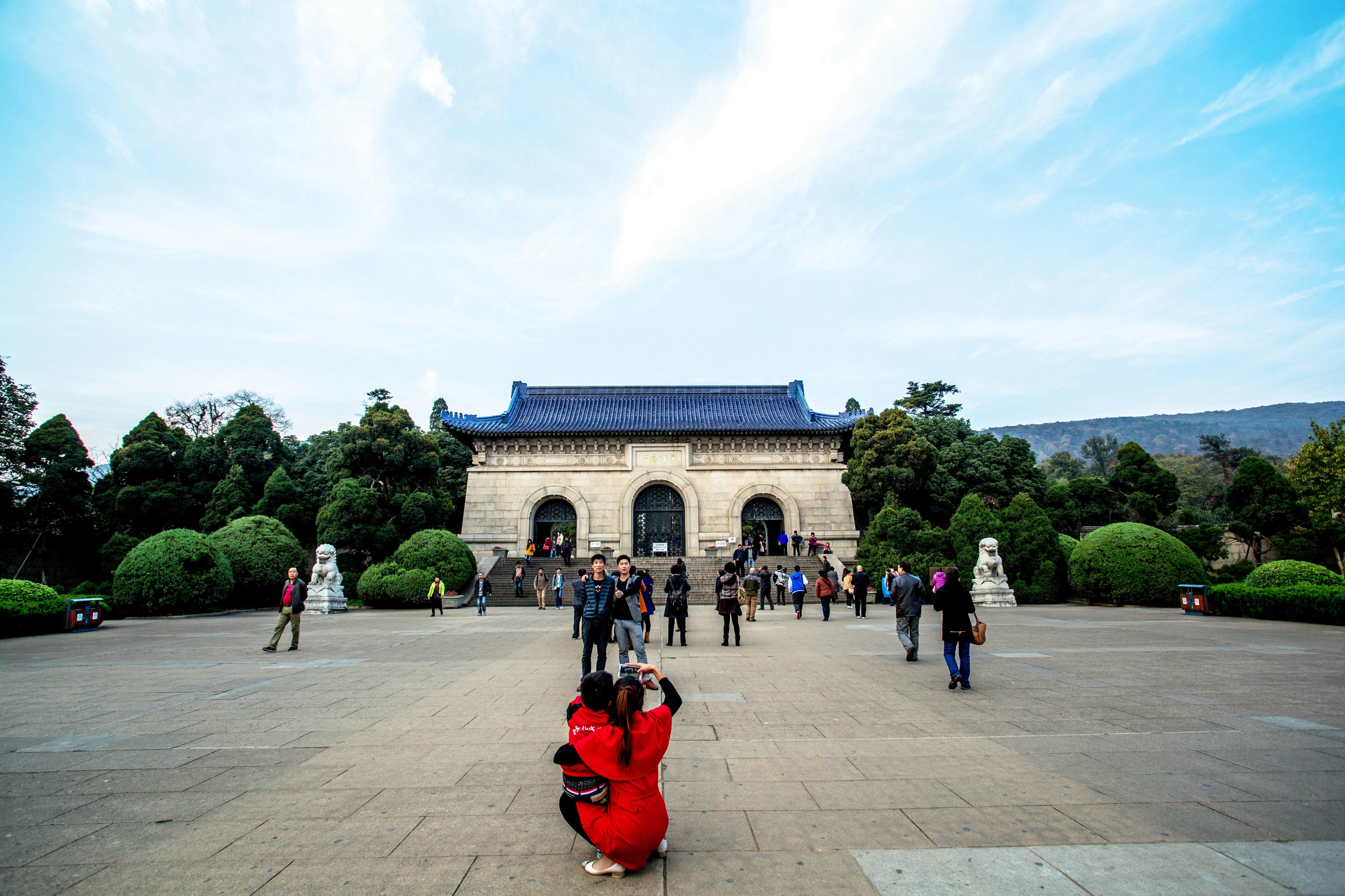 NANJING, CHINA - 2014/11/12: Tourists take photos in front of Dr. Sun Yat-sen's Mausoleum. Sun's Mausoleum situated at the foot of Mount Zijin in Nanjing,  Sun is considered to be the "Father of Modern China" both in mainland China and Taiwan, as well as the founder of Republic of China.  As the Holy land of Chinese people both home and abroad, Dr. Sun Yat-sen's Mausoleum attracts a lot of visitors every year. (Photo by Zhang Peng/LightRocket via Getty Images)
