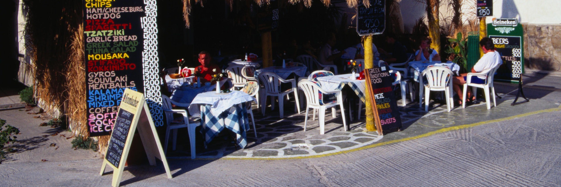 Taverna: cafe tables under a thatch roof for a traditional outdoor experience - Hersonisos, Crete