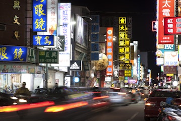Motion blurred traffic, shopping street at night, Hualien, Taiwan