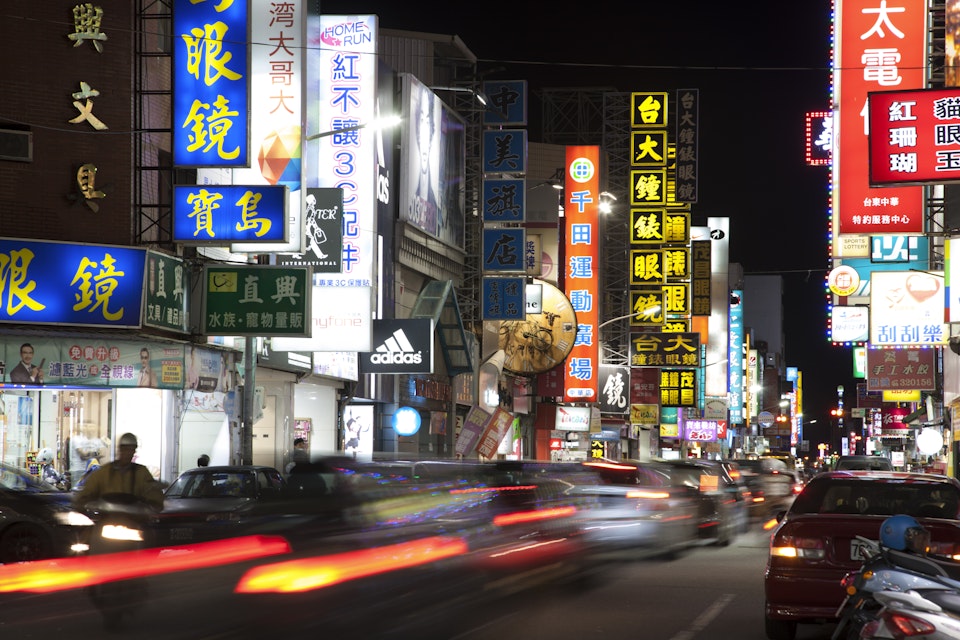 Motion blurred traffic, shopping street at night, Hualien, Taiwan