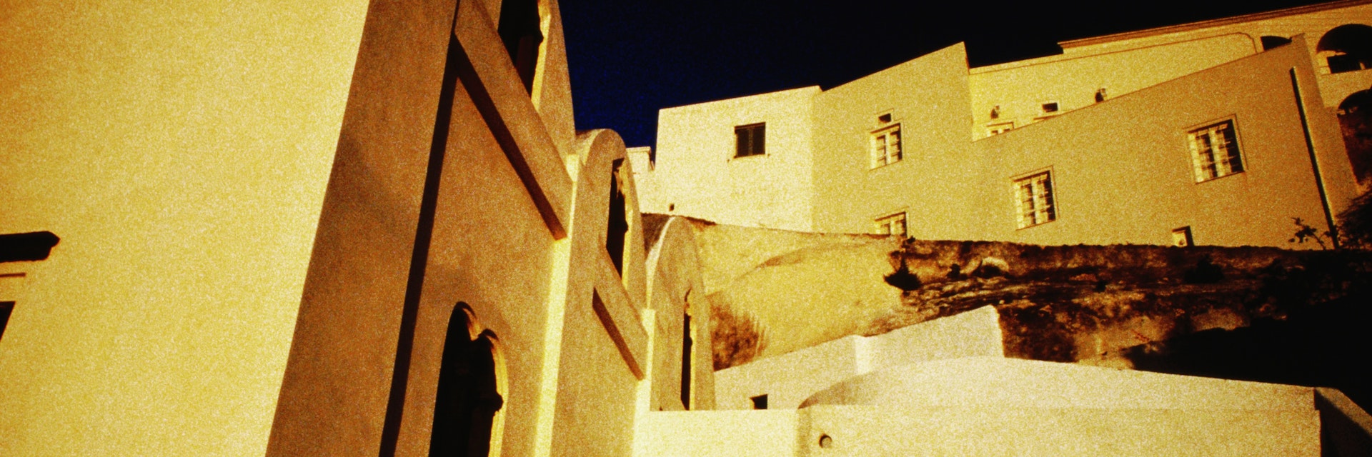 Whitewashed houses of Syros in the evening light.