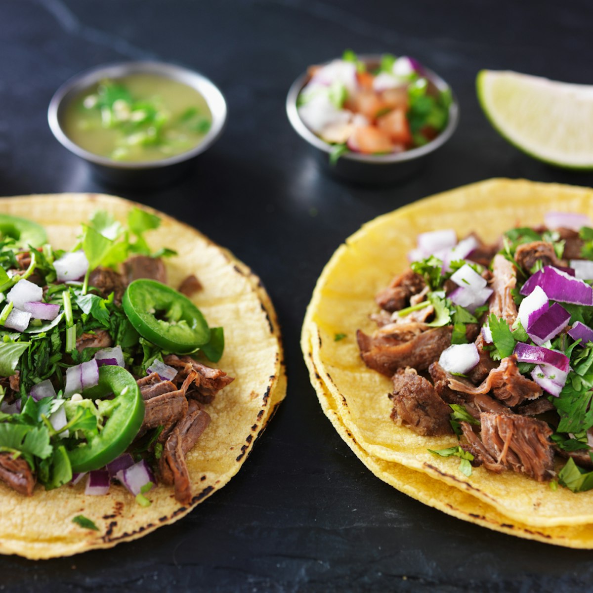 500px Photo ID: 103772725 - two authentic mexican tacos with barbacoa and carnitas on slate table top