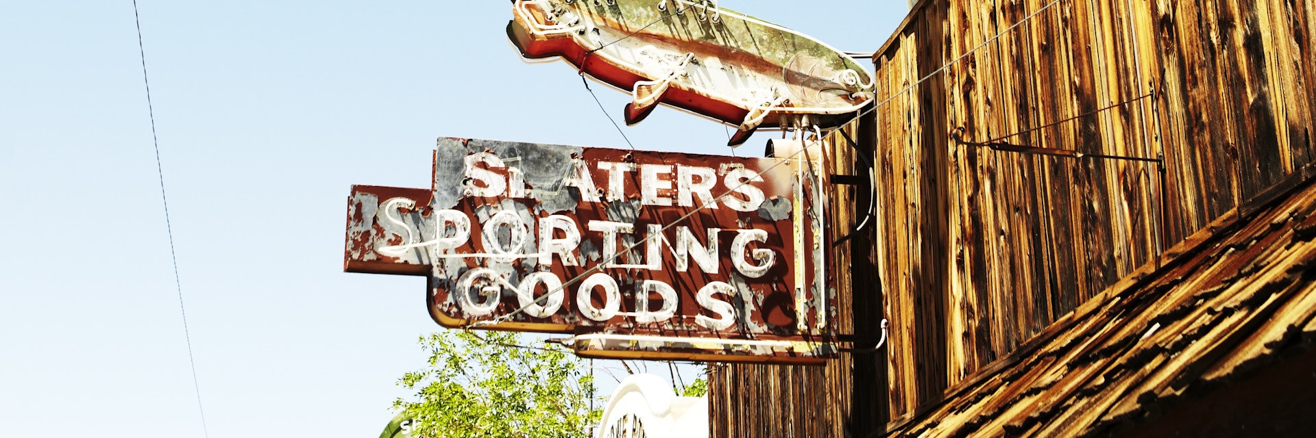 Faded signage on sporting goods store.
