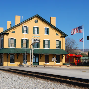 Flags from the veterans memorial fly behind the train depot in Huntsville Alabama.