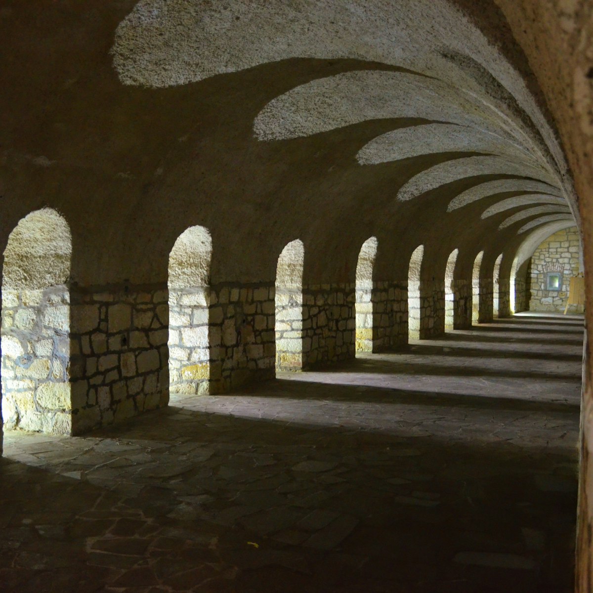 A hallway located in a fortress in K?odzko. Many windows with arches create beautiful shadows