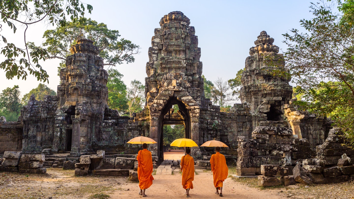 Buddhist monks walking inside Angkor Wat temple