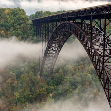 The New River Gorge Bridge is a steel arch bridge 3,030 feet (924 m) long over the New River Gorge near Fayetteville, West Virginia, in the Appalachian Mountains of the eastern United States. The New River Gorge Bridge was for many years the worlds longest single-span arch bridge; it is now the third longest and one of the highest vehicular bridges in the world.