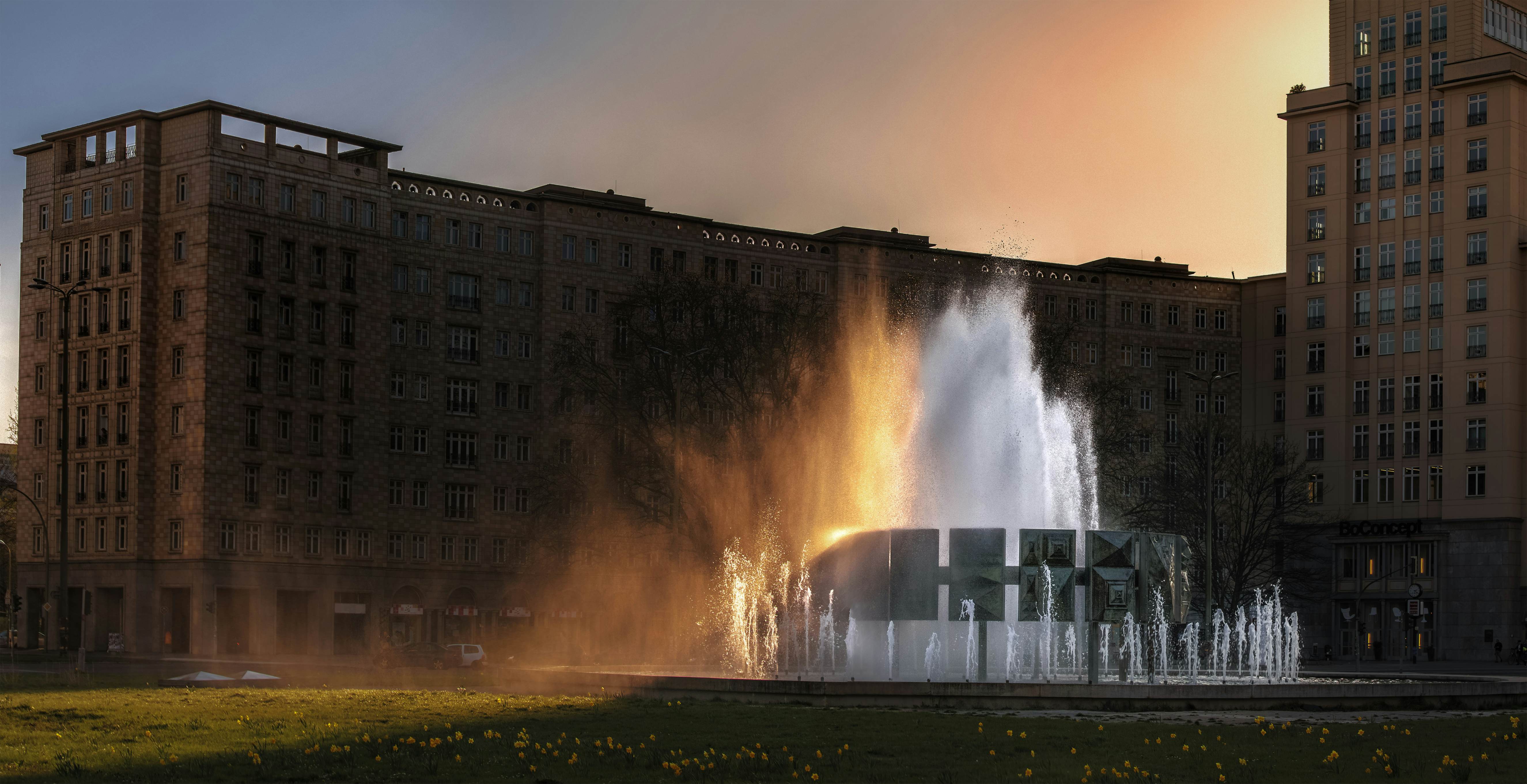 500px Photo ID: 109170205 - The grand fountain in Karl-Marx-Allee, Strausbergerplatz, .The setting sun colours the spray.