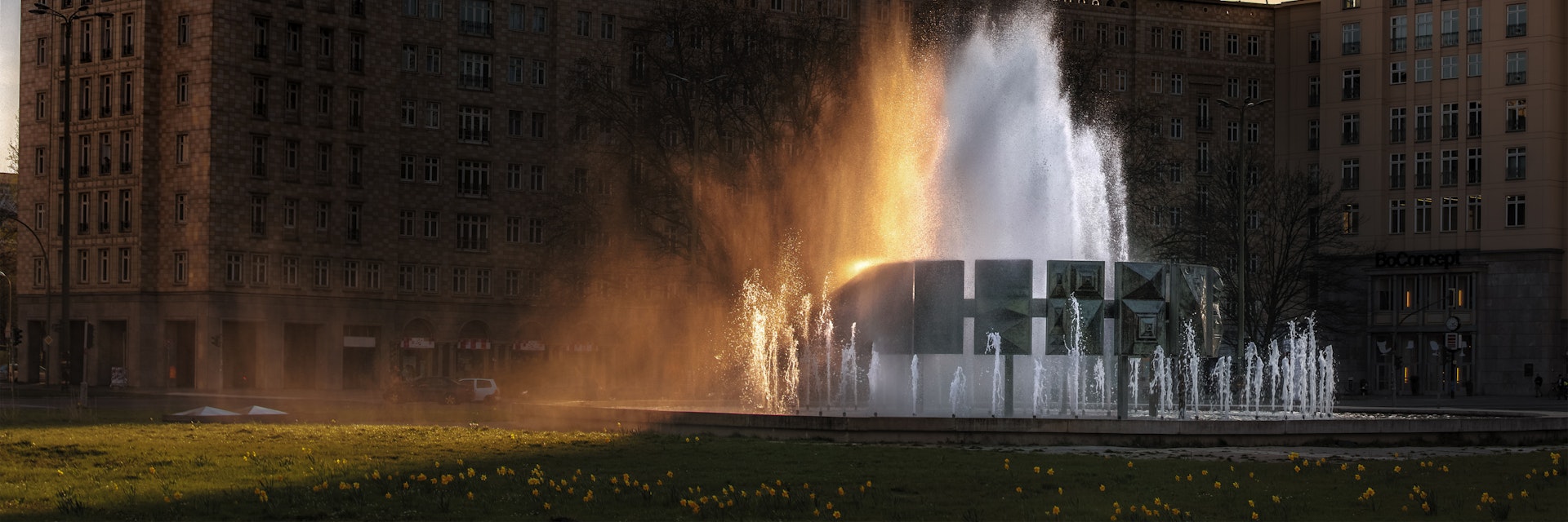 500px Photo ID: 109170205 - The grand fountain in Karl-Marx-Allee, Strausbergerplatz, .The setting sun colours the spray.