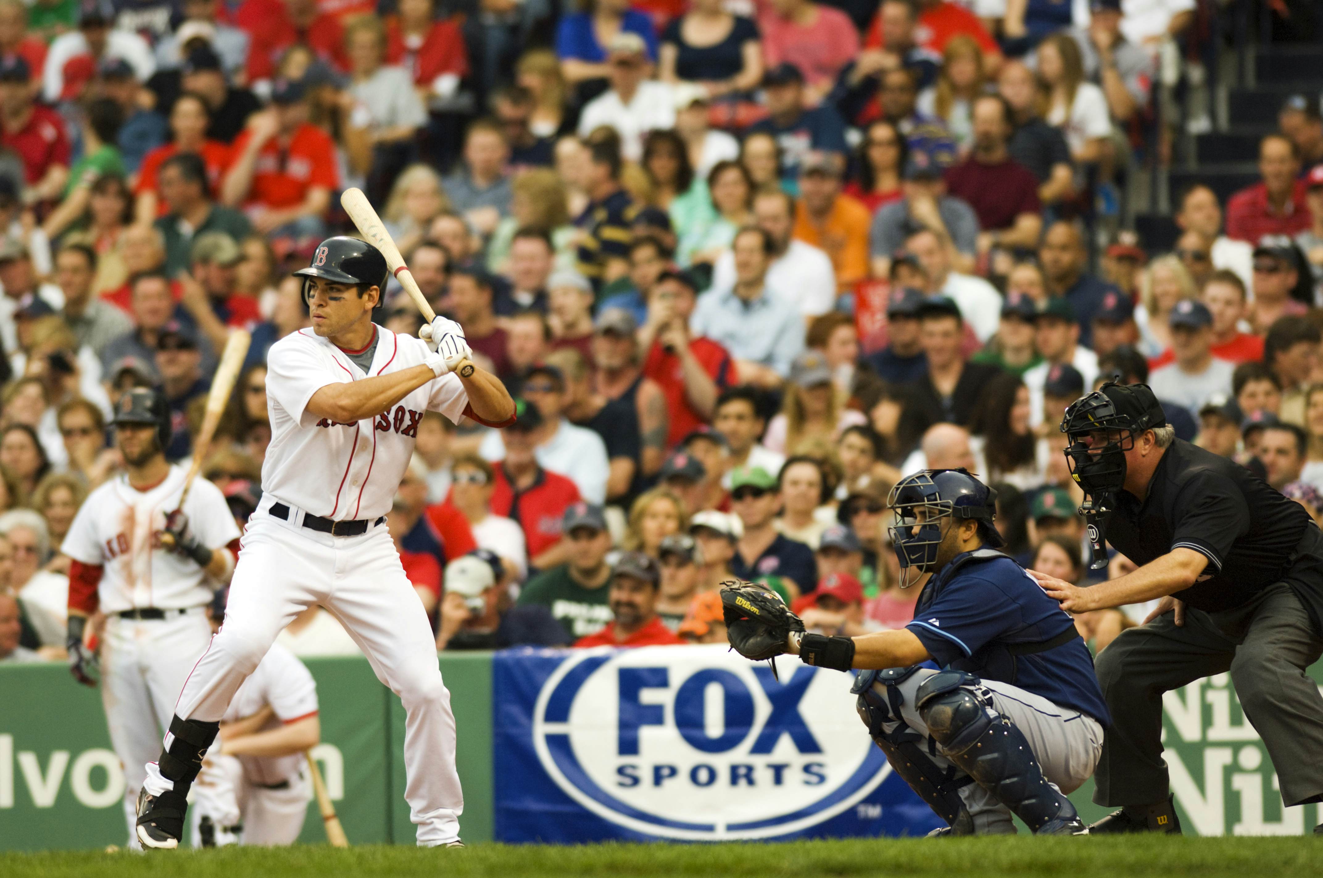 Baseball batter and catcher about to face ball at Fenway Park.