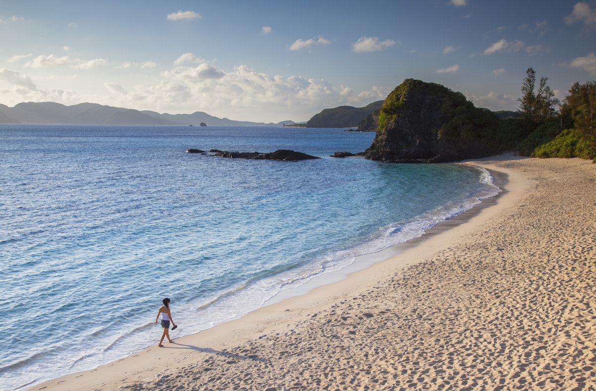 Japan, Okinawa, Kerama Islands, Zamami Island, Woman walking on Furuzamani Beach