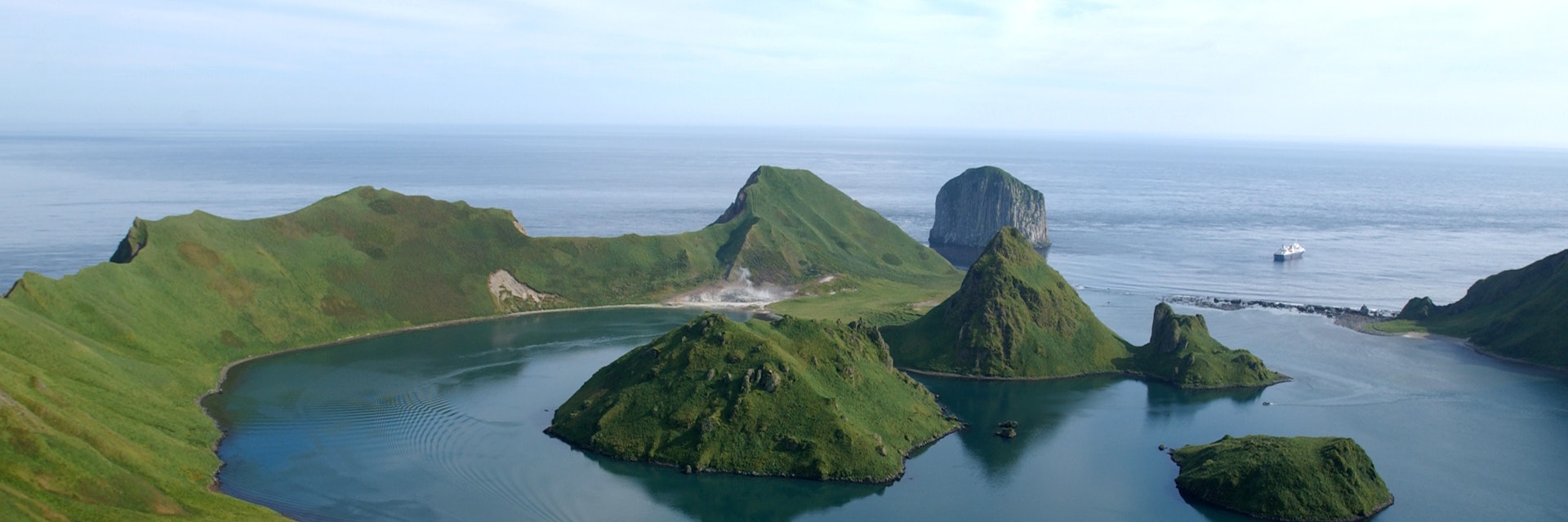Asia, Russia, Russian Far East, Kamchatkan Peninsula, Kuril Islands, Yankicha Island. Bay with small mountainous islands