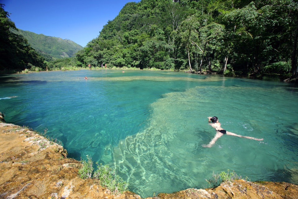 Visitors swimming in turquoise-coloured waters of Semuc Champey.
