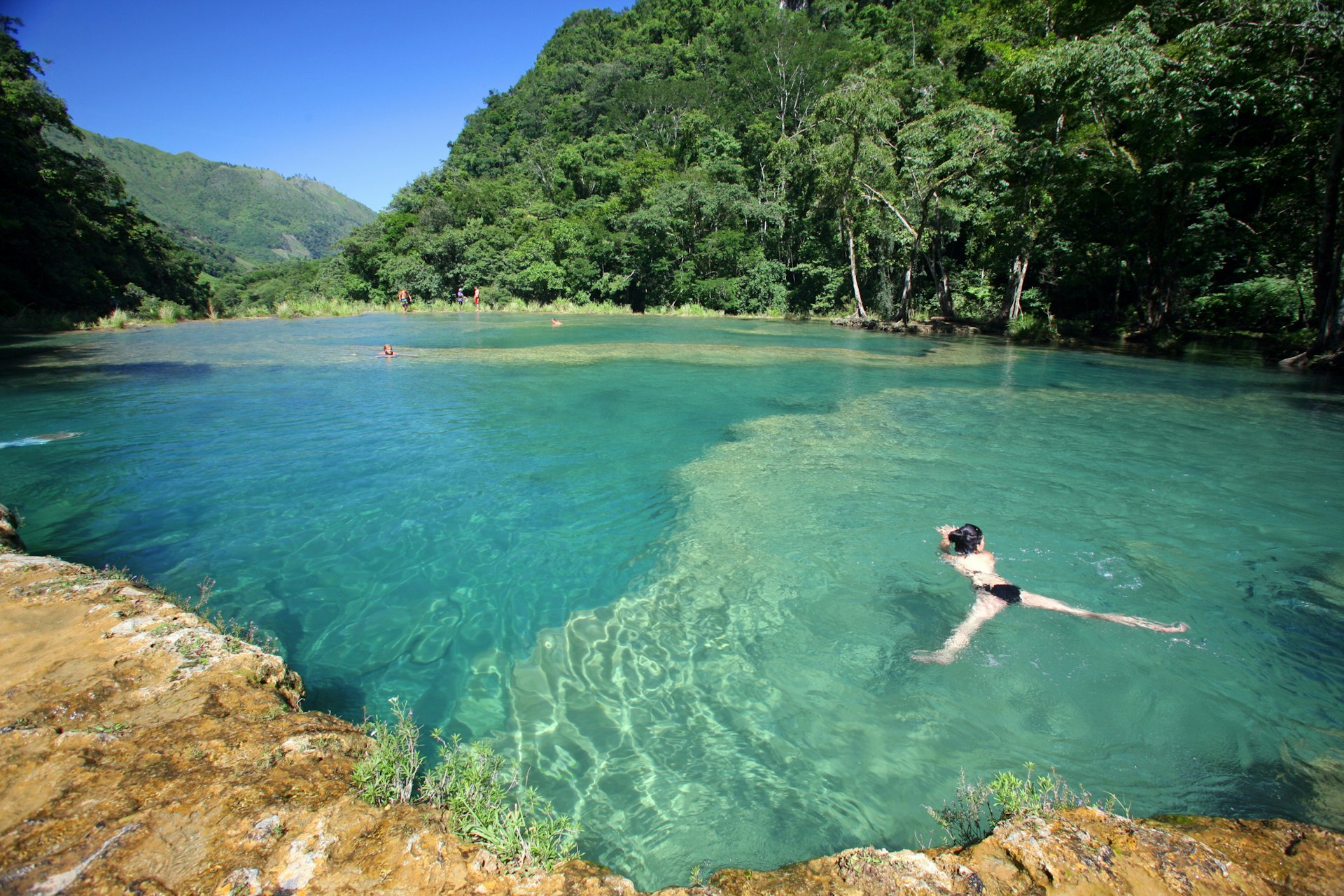 Visitors swimming in turquoise-coloured waters at Semuc Champey