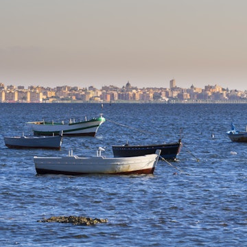 Italy, Sicily, Province of Trapani, Fishing boats and Marsala in the background