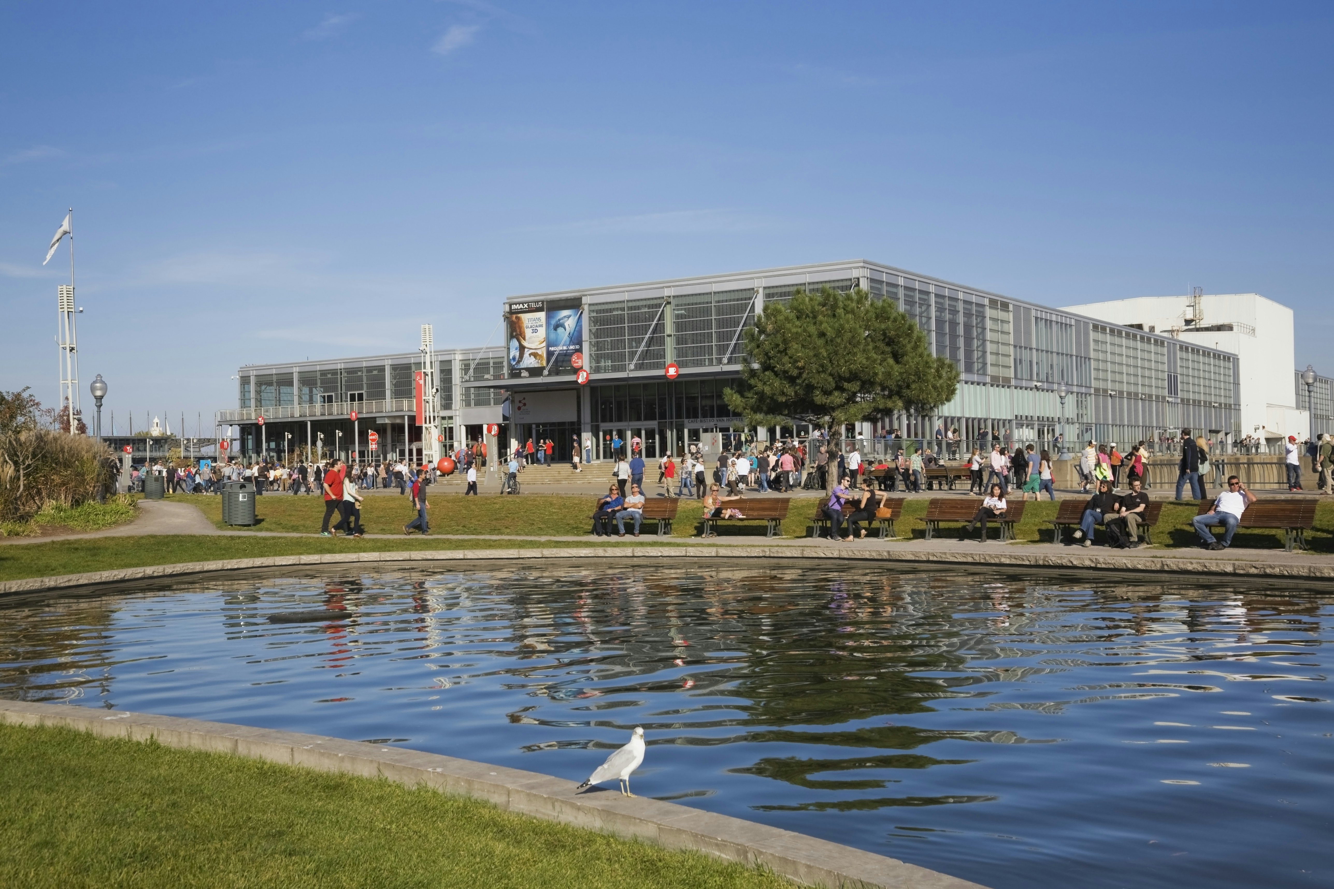 Man-made pond and the Centre des Sciences de Montreal ,Montreal Science Centre,  in the Old Port of Montreal in autumn, Quebec, Canada