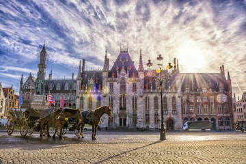 Horse carriages on Grote Markt square in medieval city Brugge at morning on background sunrise, Belgium. Shallow depth of field; Shutterstock ID 469563257; Your name (First / Last): redownload; GL account no.: redownload; Netsuite department name: redownload; Full Product or Project name including edition: redownload