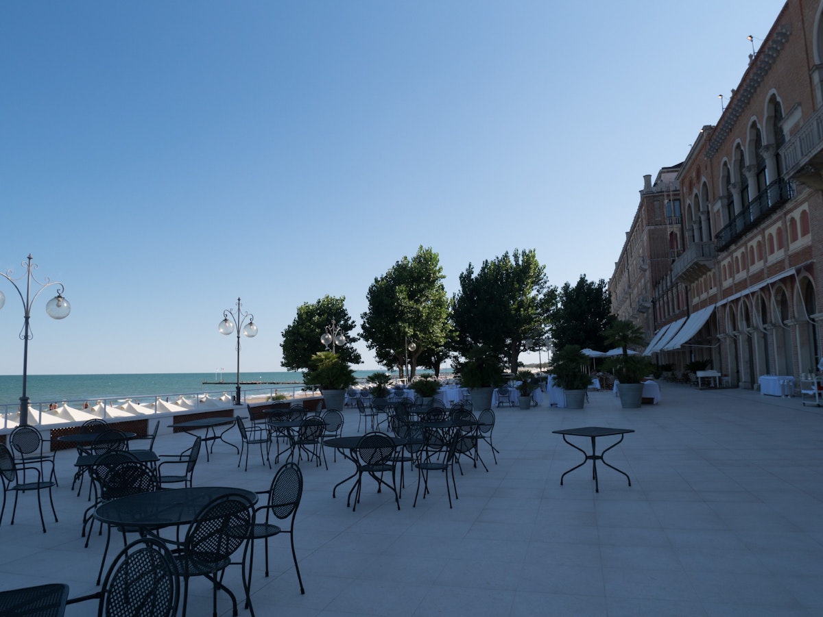 The elegant terrace overlooks the Hotel Excelsior beach
