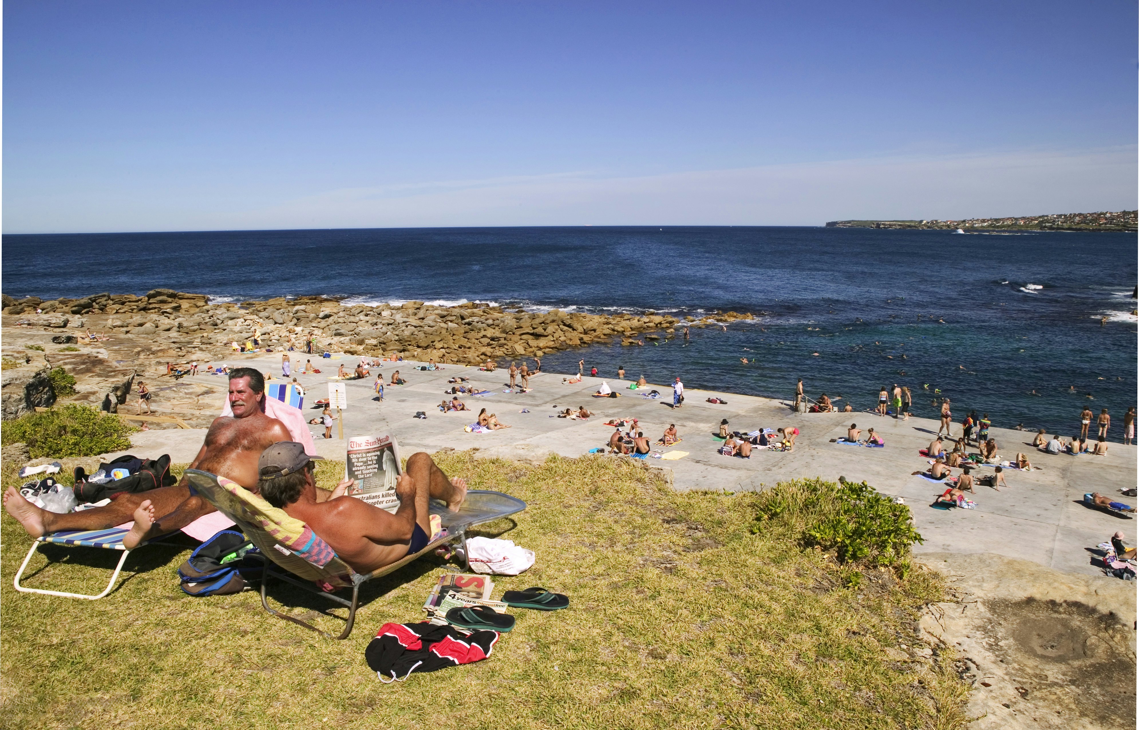People sunbathing, swimming and snorkelling at the north side of Clovelly Beach.