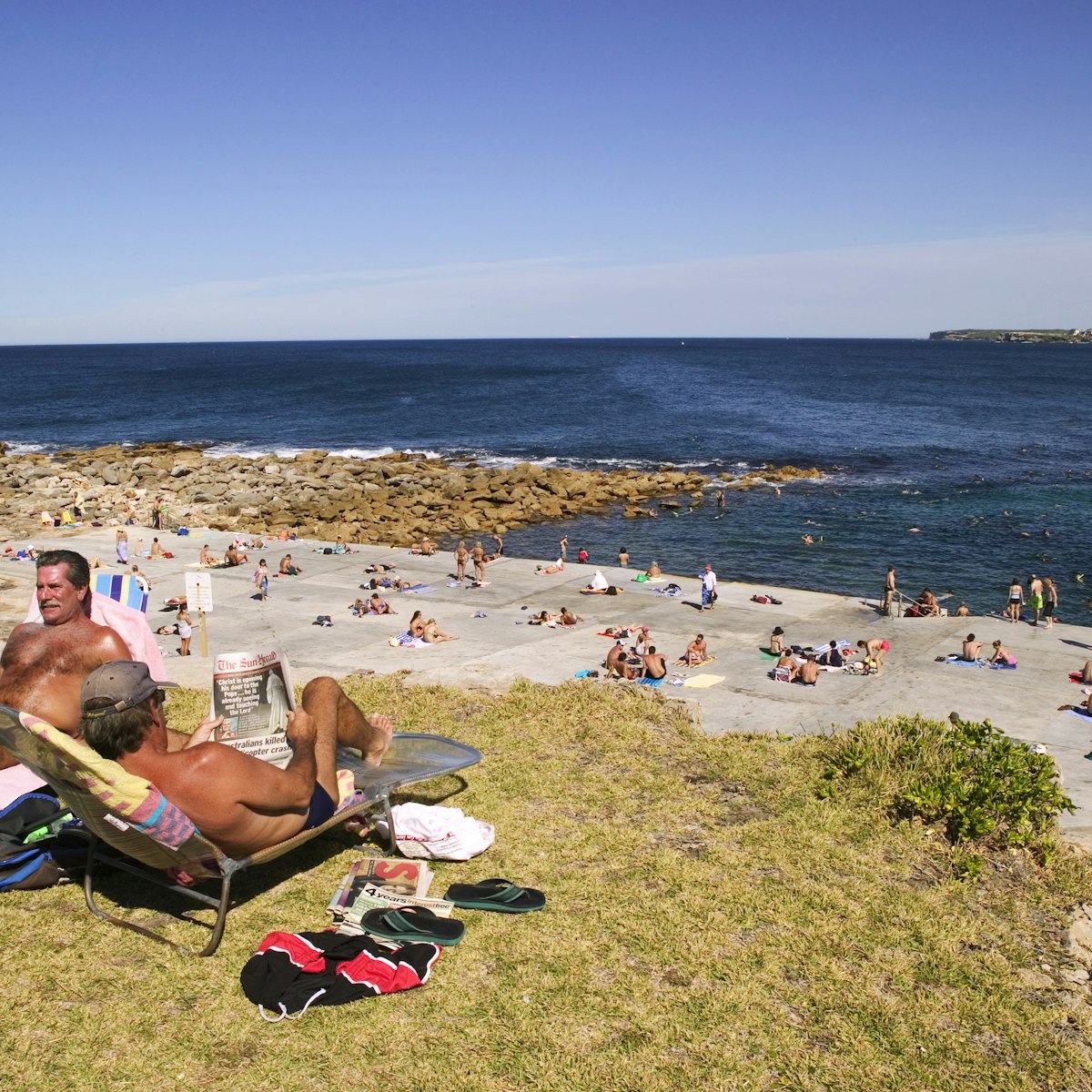 People sunbathing, swimming and snorkelling at the north side of Clovelly Beach.
