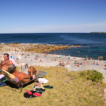 People sunbathing, swimming and snorkelling at the north side of Clovelly Beach.