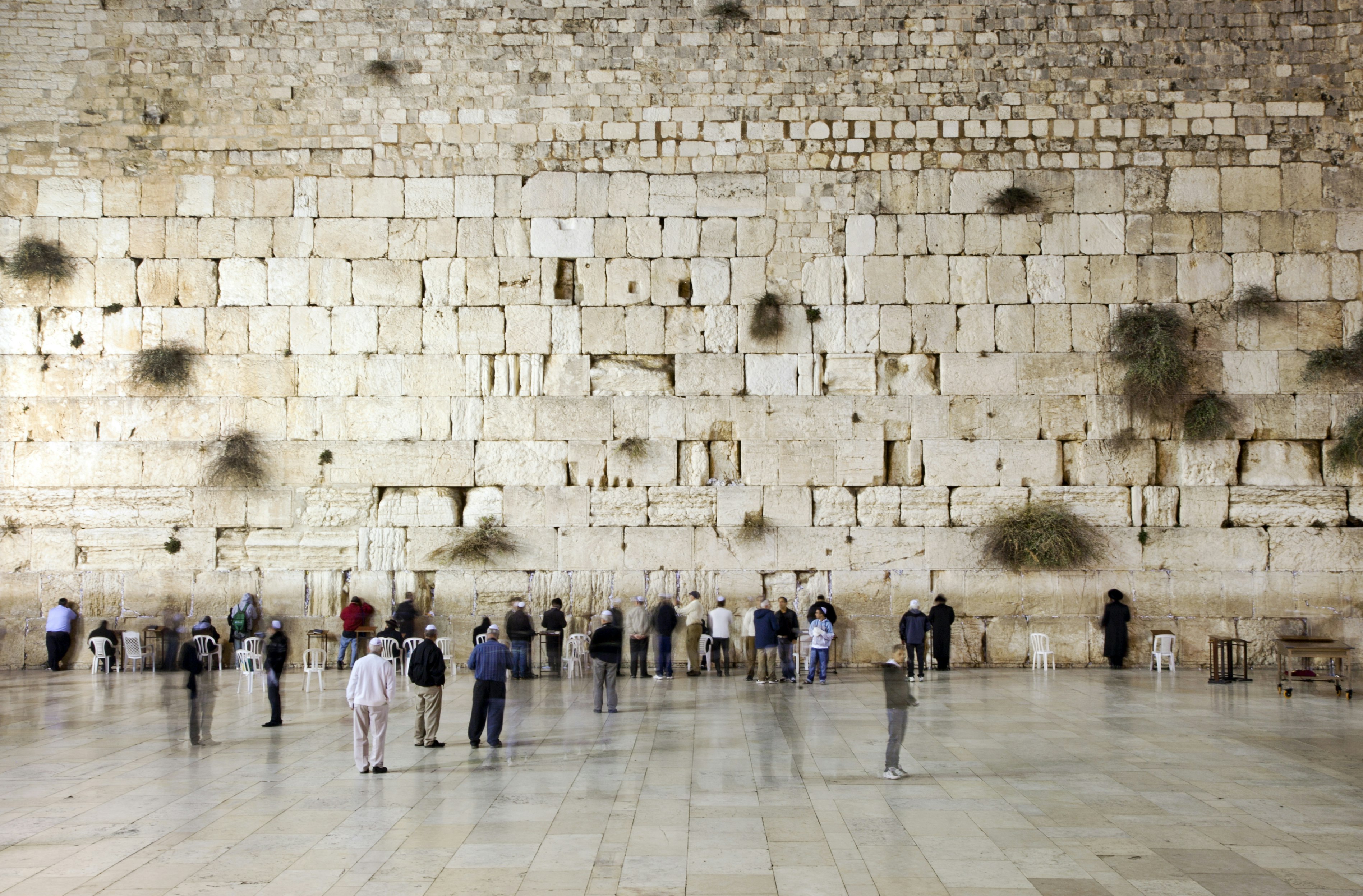 People prays and walk in front of the western wall, wailing wall or kotel.