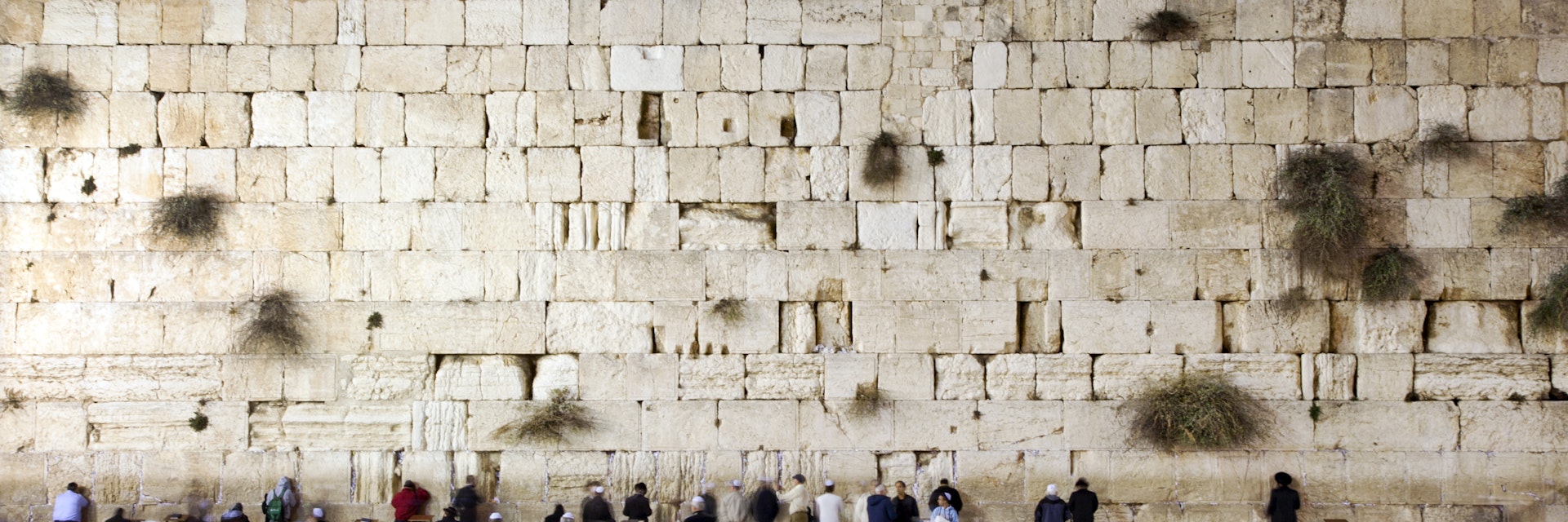 People prays and walk in front of the western wall, wailing wall or kotel.