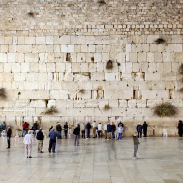 People prays and walk in front of the western wall, wailing wall or kotel.