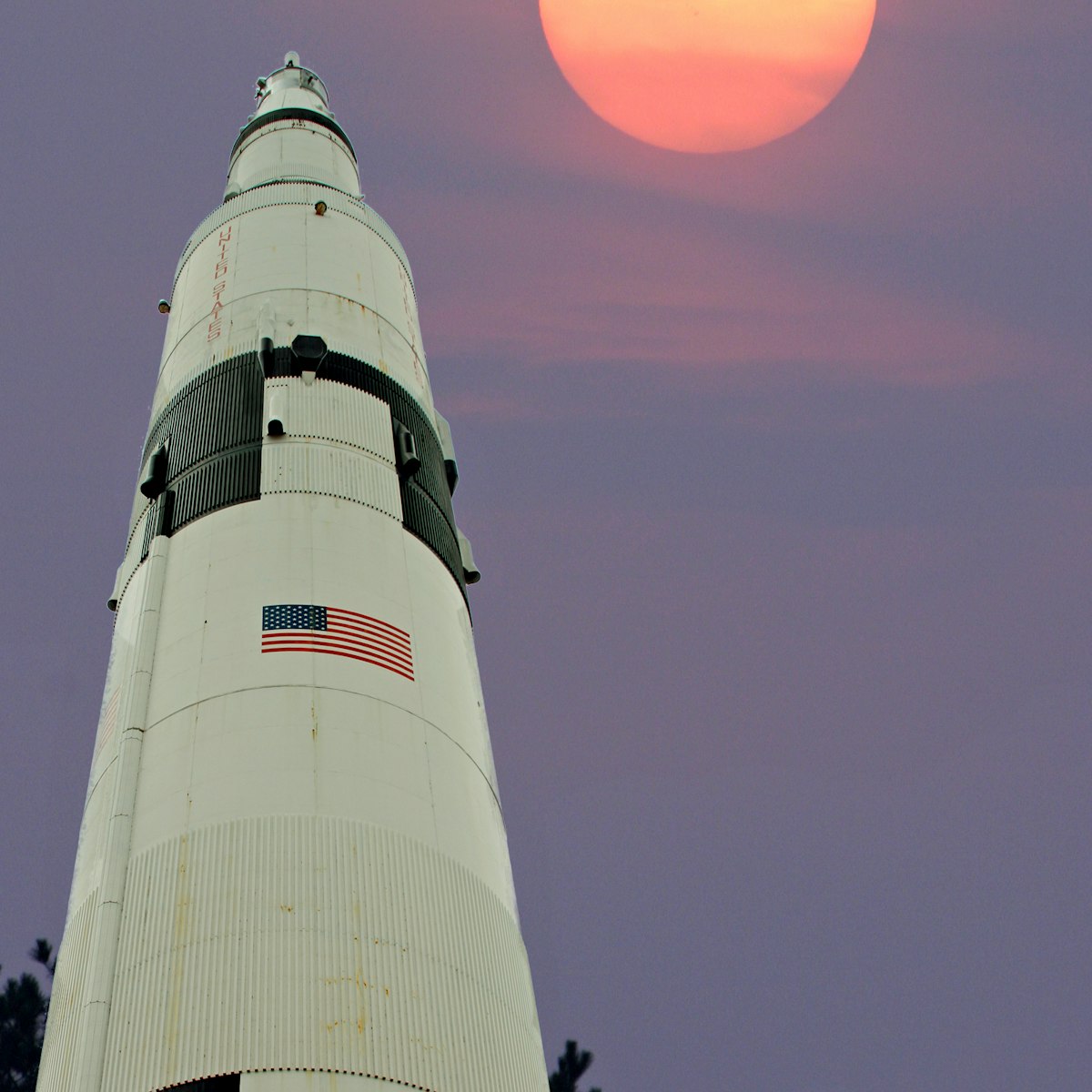 A Saturn 5 rocket appears to be aimming for the moon. The background was taken 10/22/04 at 5:30 pm CST. Taken with a Canon 10D, w/400mm lens set to 400mm. Tv 1/500, Av 8, ISO 400. White balance set to Flurescent. The shot was taken from my front porch in Harvest Al. The Sature 5 was taken 2/17/14 at 2:30 PM CST. at the Space and Rocket center in Huntsville Al. This shot was taken with a canon 7D, with a 28-135 lens set at 28mm. Tv 1/125, Av 6.3, exposure compensation plus 1 and ISO 100. Post process was on the background with PS elements 5, and the rocket with PS element 11 and Perfect photo suite 8.