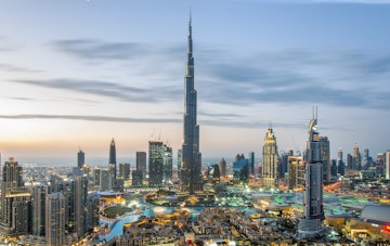 DUBAI, UAE - February 18: Burj Khalifa the tallest building in the world. Dubai Downtown cityscape. Dubai evening skyline, busy roads, sunset on February 18, 2017 in Dubai.; Shutterstock ID 626215625; Your name (First / Last): Lauren Keith; GL account no.: 65050; Netsuite department name: Online Editorial; Full Product or Project name including edition: Dubai Neighbourhoods Update