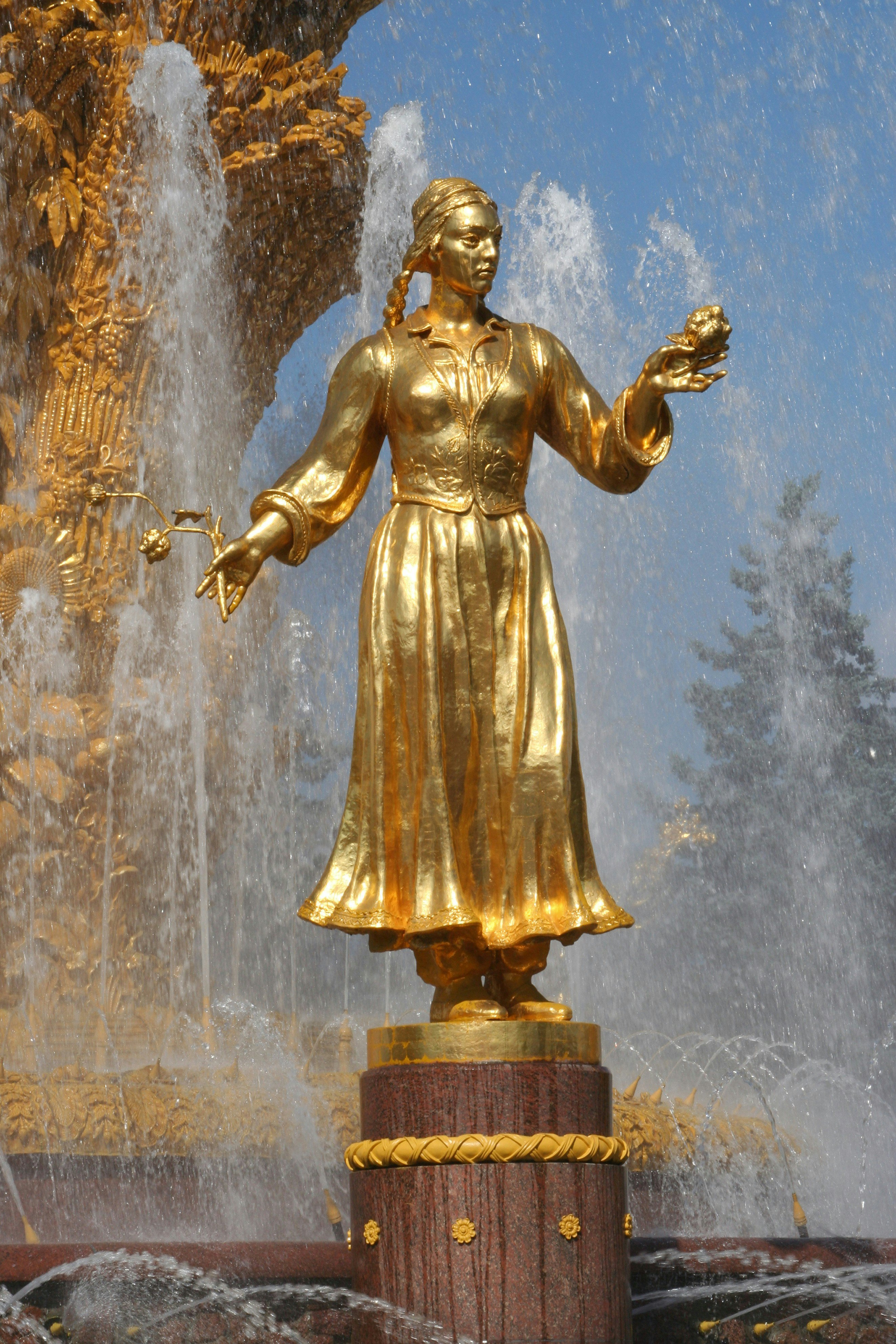Golden statue in Friendship of the People Fountain at VDNKh (trade fair and amusement park).