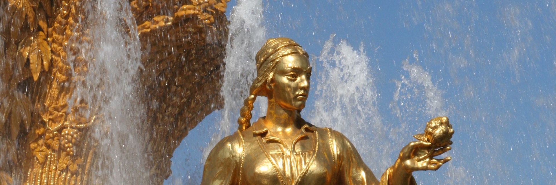 Golden statue in Friendship of the People Fountain at VDNKh (trade fair and amusement park).