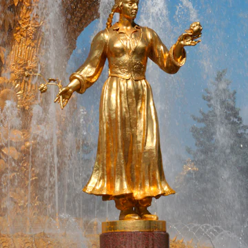 Golden statue in Friendship of the People Fountain at VDNKh (trade fair and amusement park).