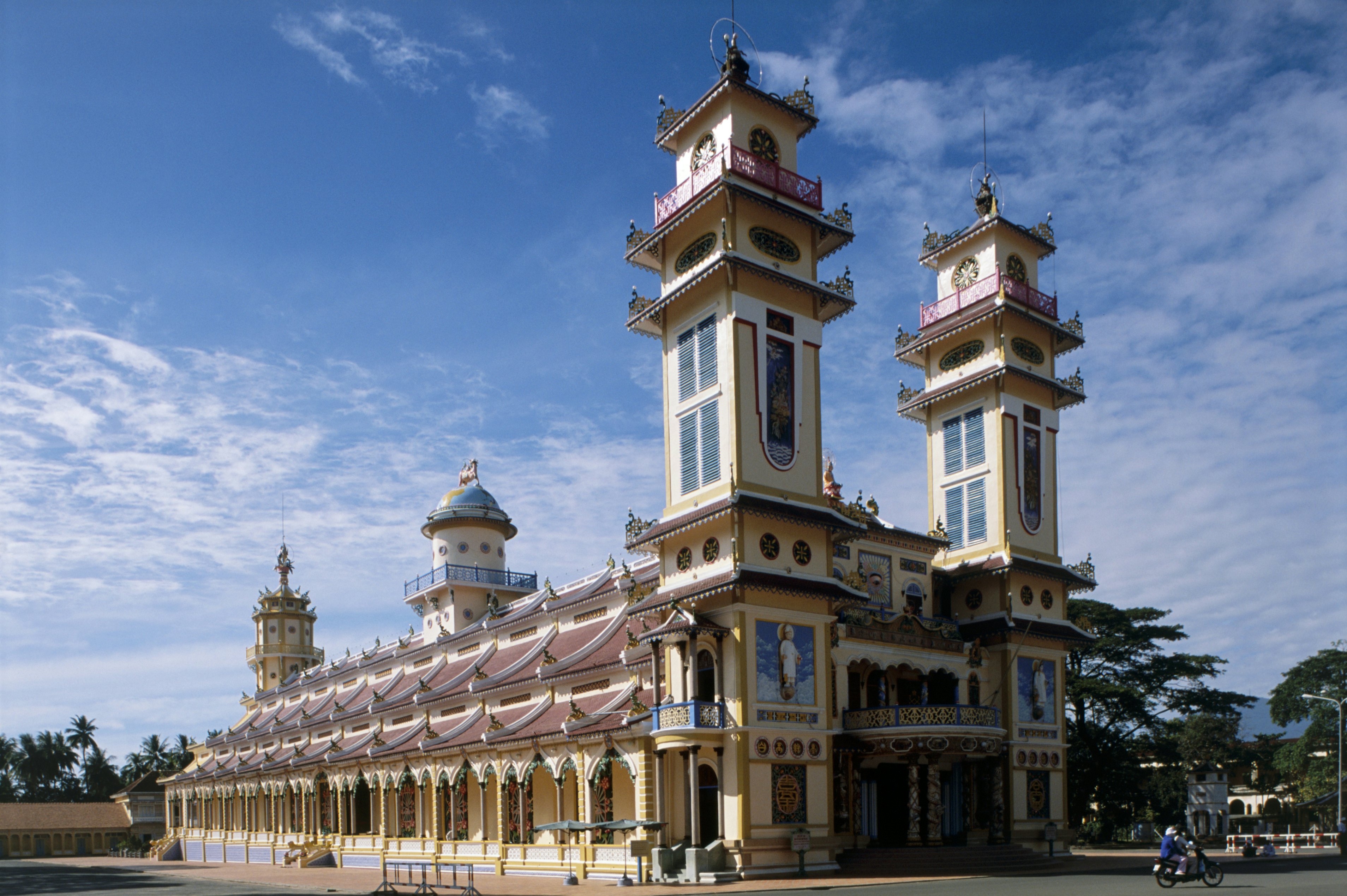 Vietnam, Tay Ninh, Cao Dai Holy See, (Great Divine Temple) with pair towers and blue sky above